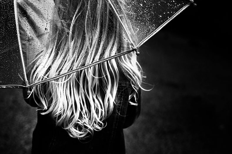 Photo: Person in rain with transparent umbrella