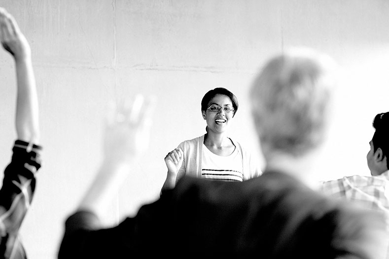 Woman teaching classroom of students