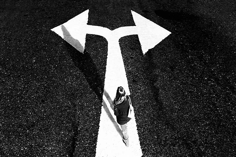 Person walking over two-way arrow.