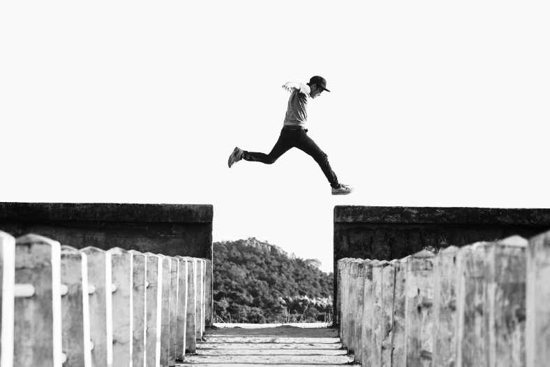 Man jumping over wall.